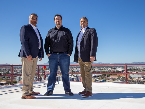three Sandoval Elevator executives proudly posing for a photo