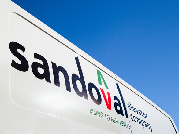 a vehicle displaying Sandoval Elevator's logo and slogan