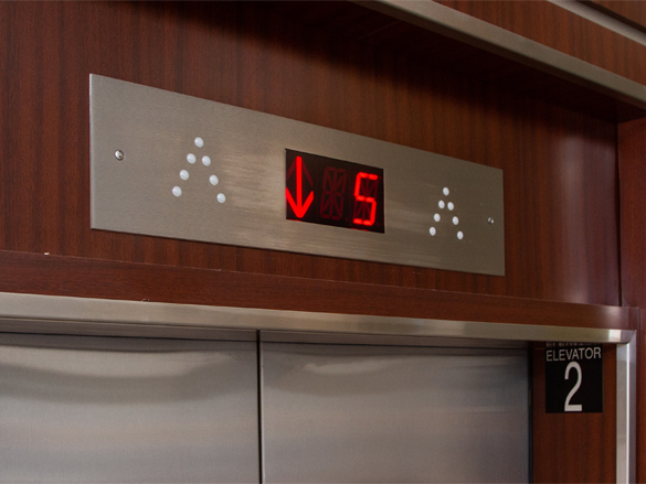an elevator floor indicator showing that an elevator is descending from the fifth floor