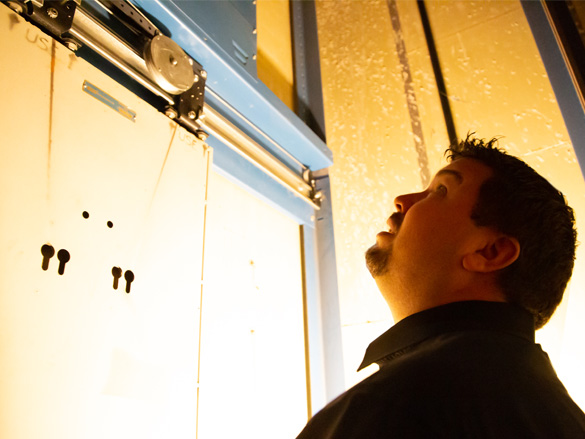 an elevator specialist assessing elevator equipment